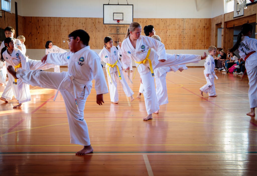 children learning to become independent and responsible during Taekwon-Do training on the floor